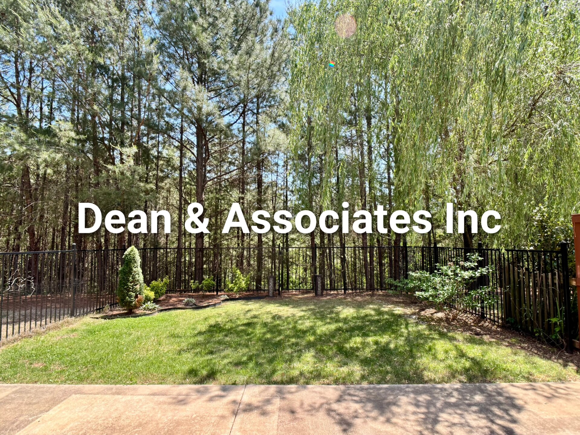 Fenced backyard with mature tree line at 463 Reach Dr townhouse rental in Birmingham, Alabama