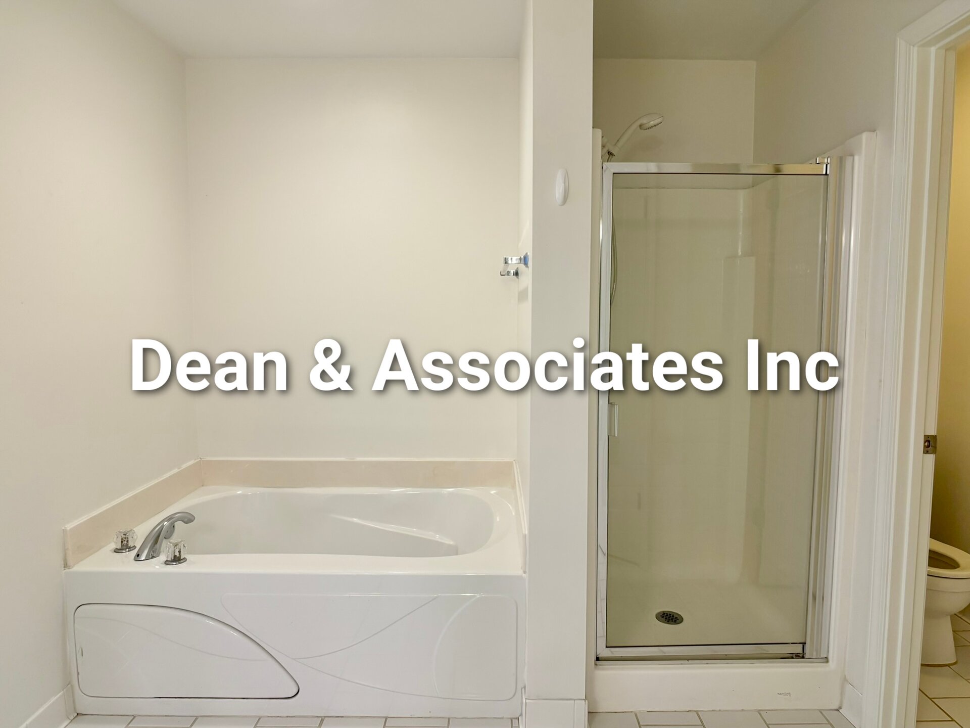 Soaking tub and glass shower in primary bathroom of 463 Reach Dr townhouse in Birmingham, AL