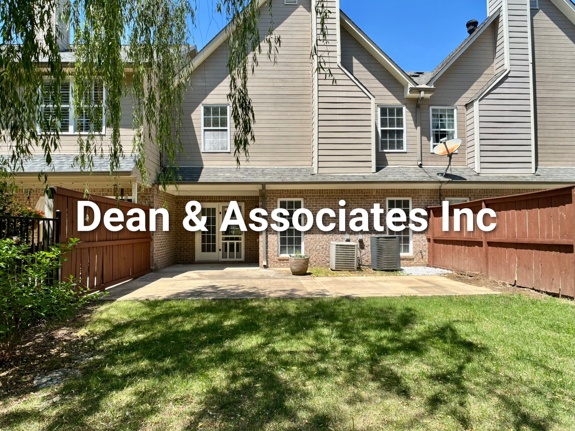 Rear exterior with concrete patio and fenced yard at 463 Reach Dr townhouse rental in Birmingham, AL