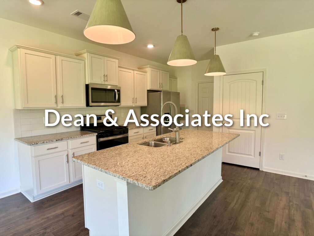 Kitchen with granite island, pendant lights, white cabinets, and stainless appliances at 464 Crossbridge Rd