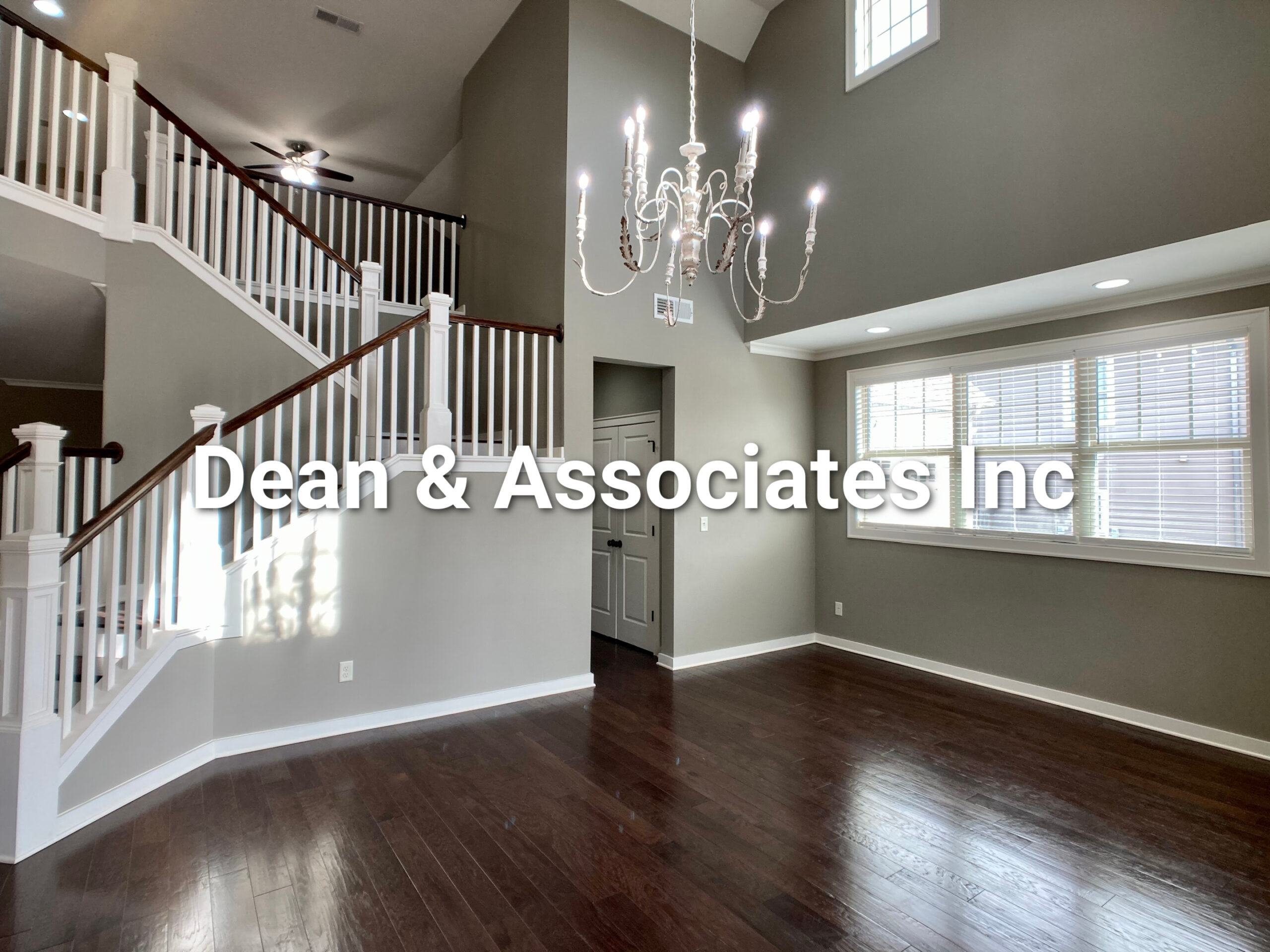 Two-story foyer with hardwood floors and staircase at 472 Lake Chelsea Way, Chelsea, Alabama rental home