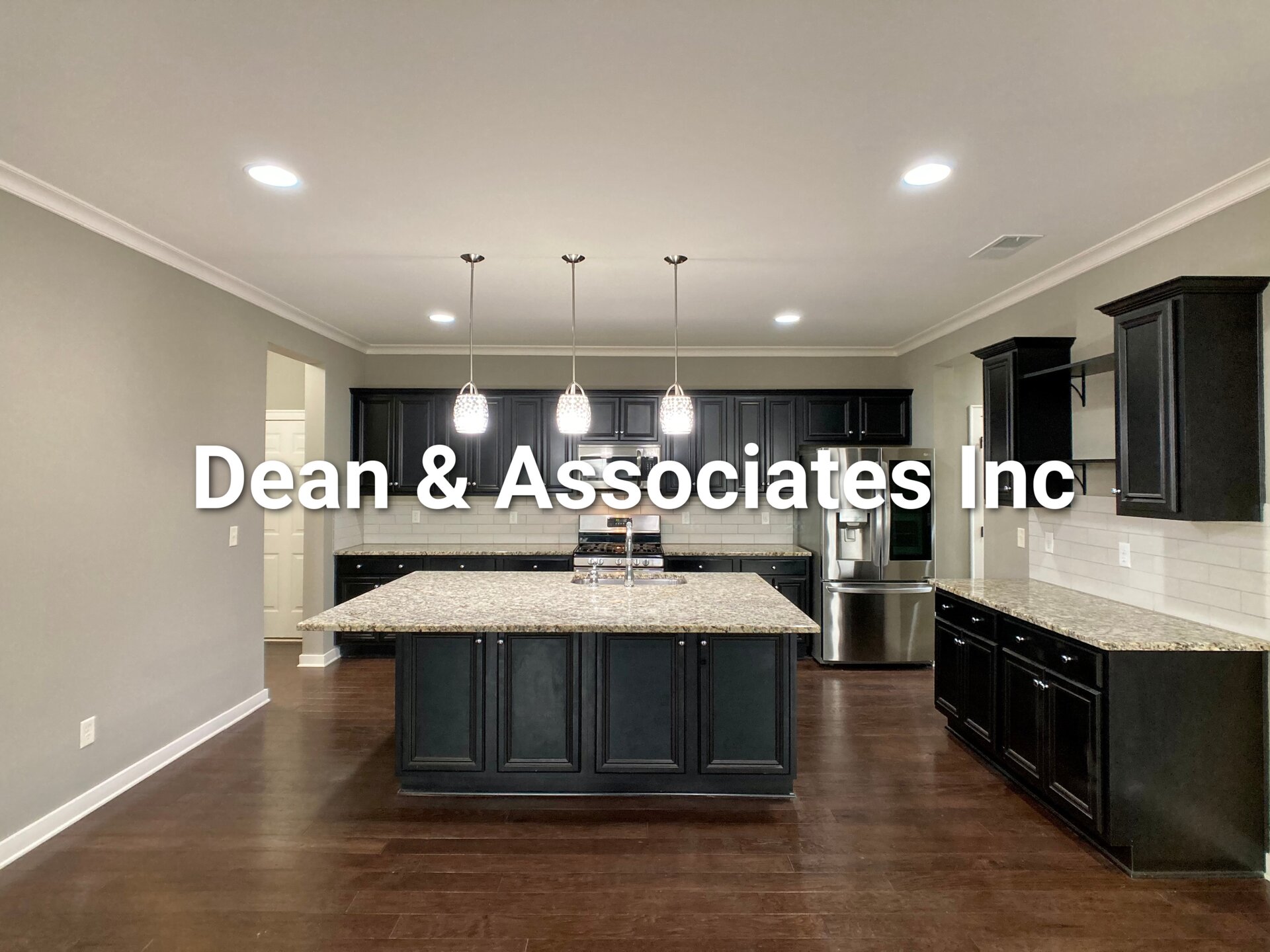 Kitchen with granite island, dark cabinets, and stainless appliances at 472 Lake Chelsea Way