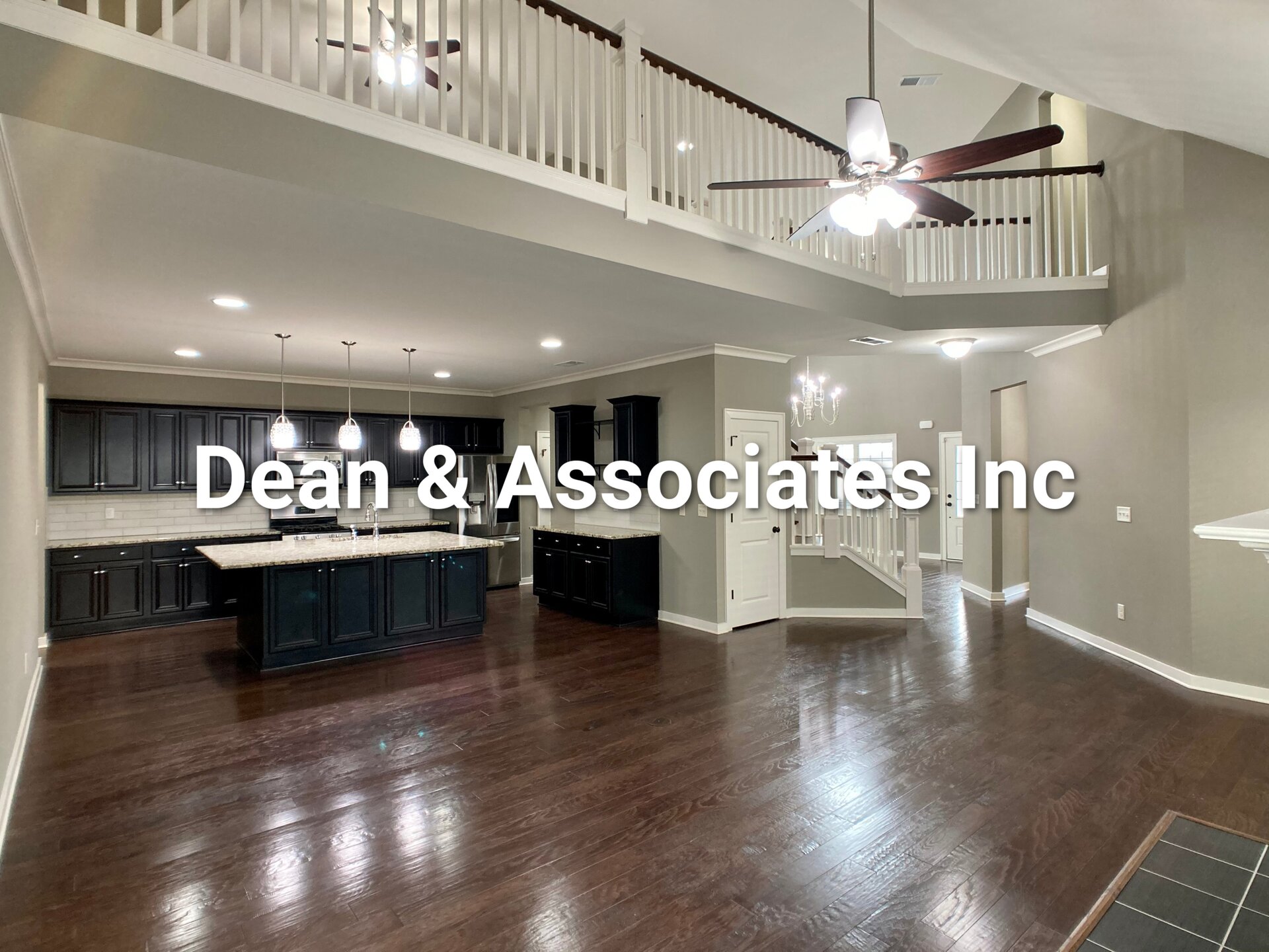Open-concept kitchen and great room with second-floor balcony at 472 Lake Chelsea Way in Chelsea, AL