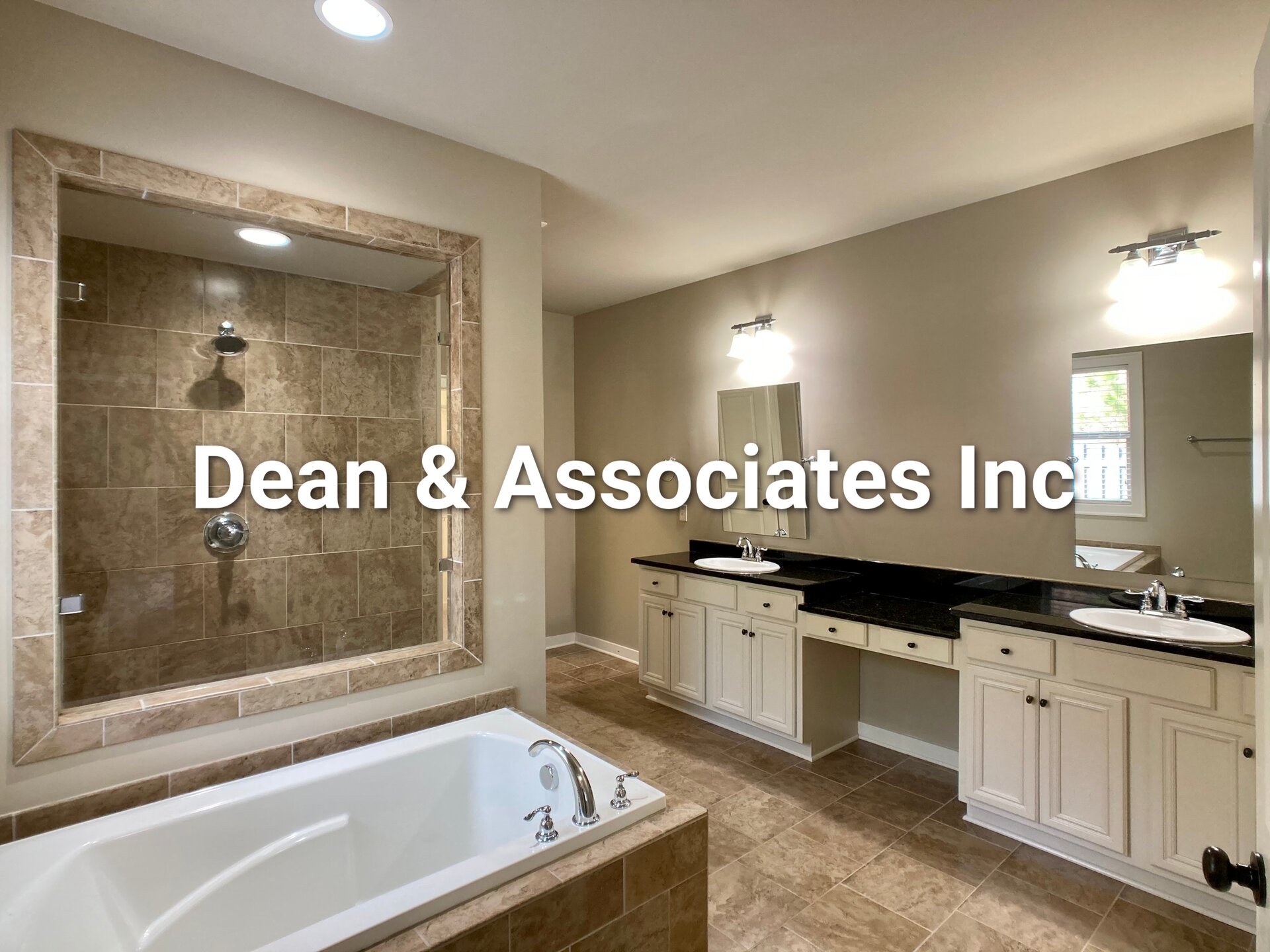 Primary bathroom with soaking tub, tiled shower, and double vanity at 472 Lake Chelsea Way